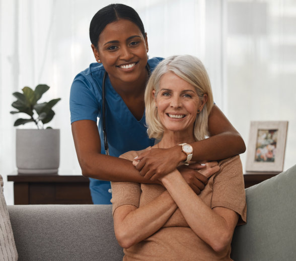aide and senior woman smiling