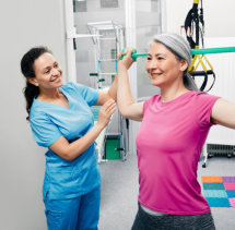 aide and senior woman having a physical therapy