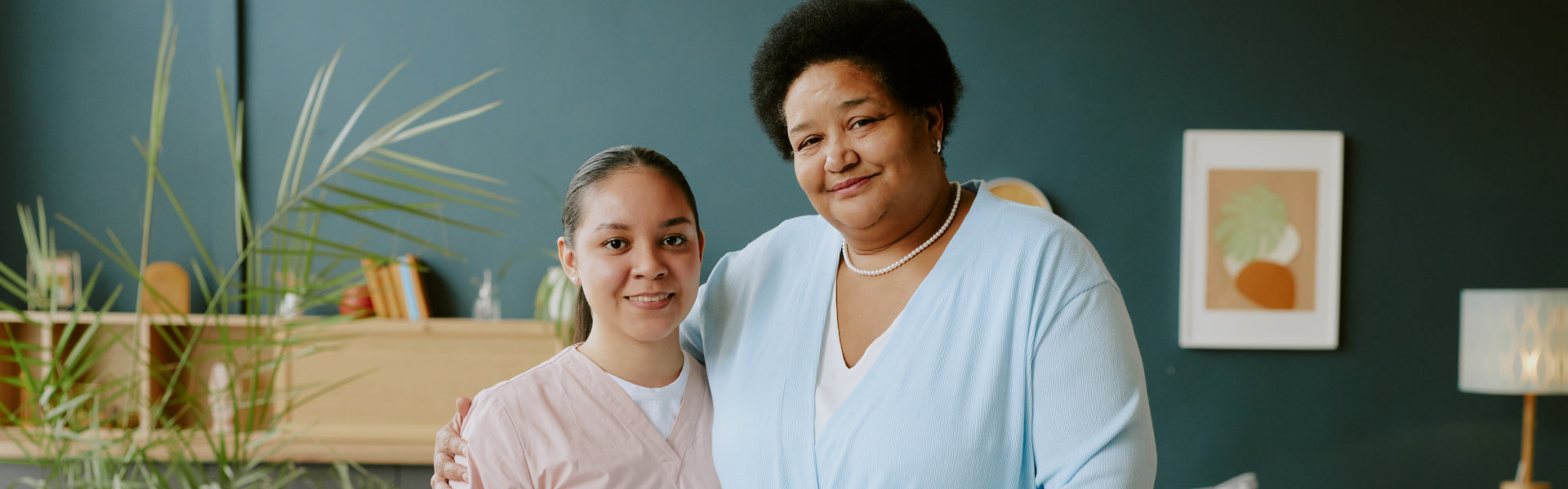 aide and senior woman having a photo together