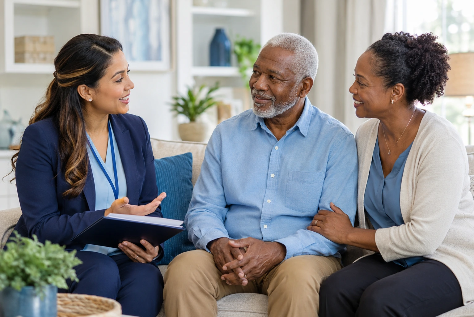 Home health care professional discussing care options with an older African American adult and family member in a bright, comfortable home.